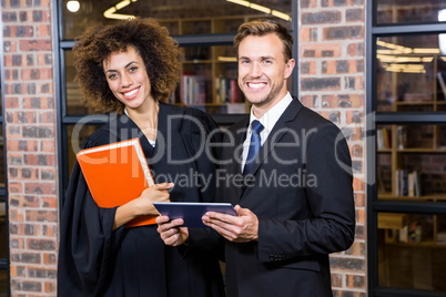 Businessman and lawyer standing near library