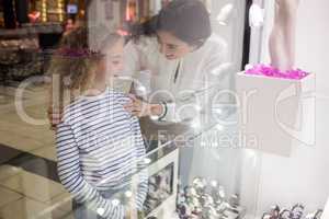 Mother and daughter selecting a wrist watch from shop display