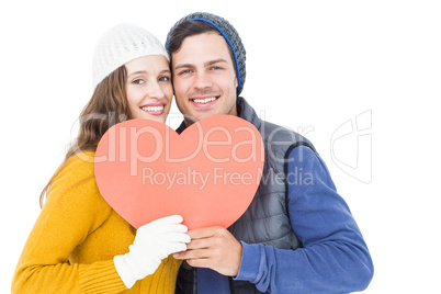 Happy couple holding paper heart