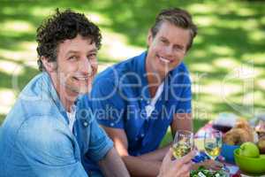 Friends having a picnic with wine