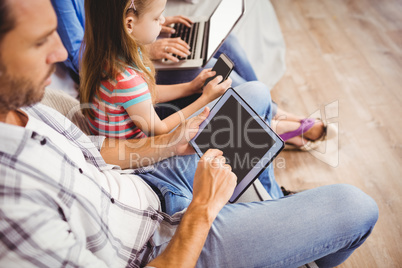 High angle view of family using technologies