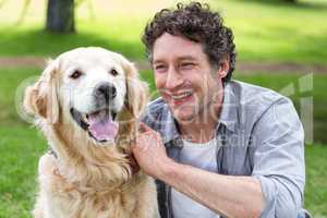 Smiling man with his dog in park