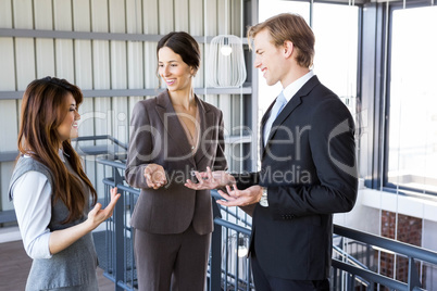 Three colleagues discussing in office