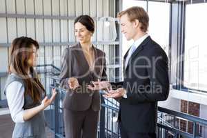 Three colleagues discussing in office