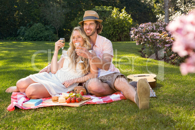 Happy couple having a picnic and embracing