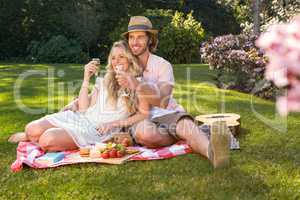 Happy couple having a picnic and embracing