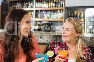 Women holding glasses of cocktail