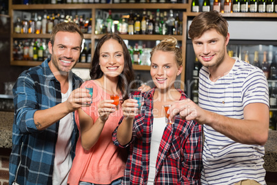 Friends toasting with shots