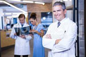 Portrait of male doctor standing with arms crossed