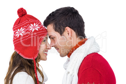 Happy couple with winter clothes embracing head to head