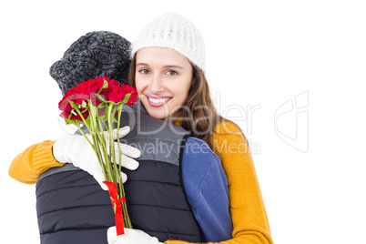 Happy couple hugging each other with flowers
