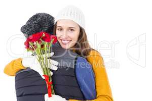 Happy couple hugging each other with flowers