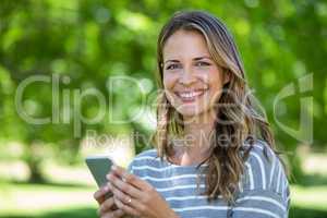 Smiling woman using smartphone