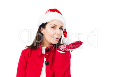 Beautiful brunette with santa hat blowing kiss