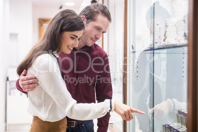 Happy couple shopping in jeweler shop