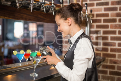 Barmaid pouring cocktail