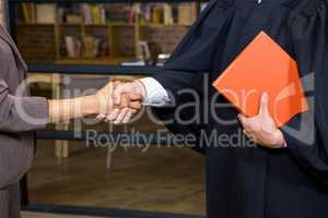 Businesswoman shaking hands with lawyer