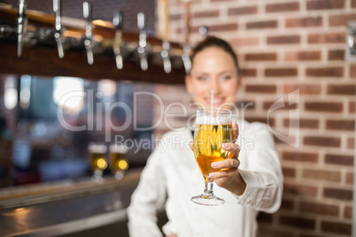 Barmaid holding a beer