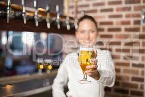 Barmaid holding a beer