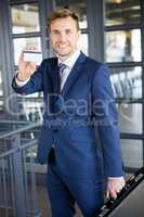 Businessman showing a credit card