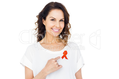 Pretty brunette pointing red aids awareness ribbon