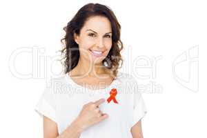 Pretty brunette pointing red aids awareness ribbon