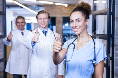 Medical team putting their thumbs up and smiling