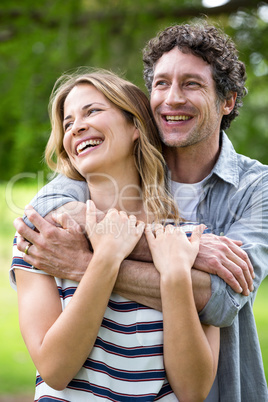 Smiling couple embracing in park