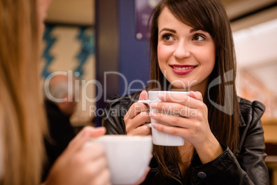 Woman smiling while having coffee