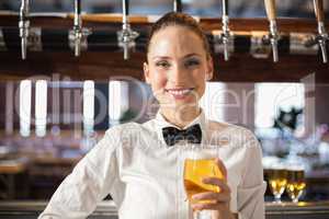 Barmaid holding a beer