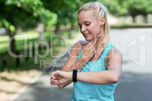 Sportswoman checking her heart rate watch