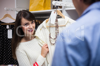 Couple selecting a dress while shopping for clothes