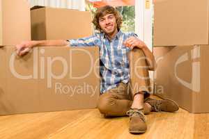 Handsome man posing with moving boxes