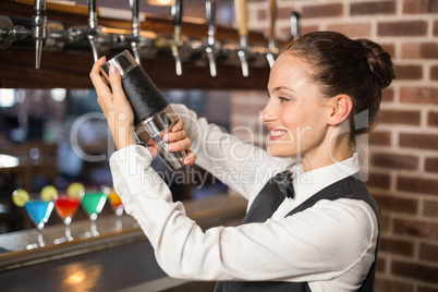 Barmaid shaking a cocktail