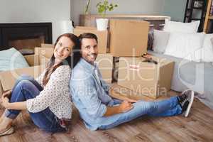Portrait of happy couple with cardboard boxes
