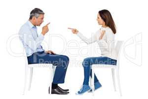 Couple arguing while sitting
