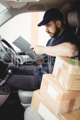 Delivery man sitting in his van