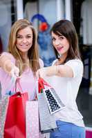 Portrait of two beautiful women shopping in mall