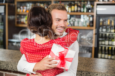 A couple hugging in a bar