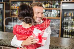 A couple hugging in a bar