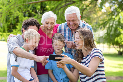 Smiling family using smartphone