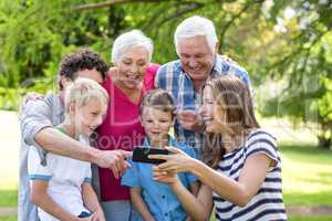 Smiling family using smartphone