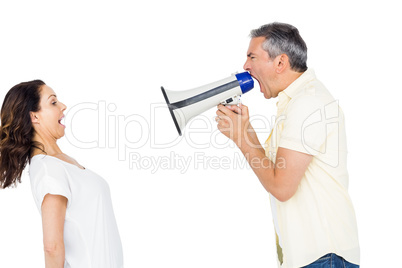 Couple shouting with man holding megaphone