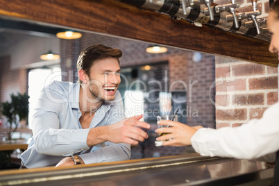 Man getting his order from barmaid