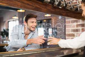 Man getting his order from barmaid