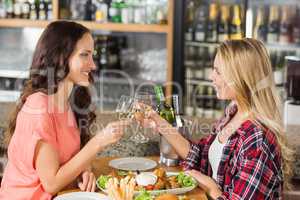 Women toasting with white wine