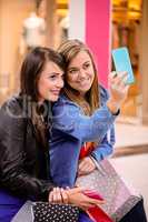 Two beautiful women taking a selfie in shopping mall
