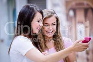 Two beautiful women taking a selfie on mobile phone