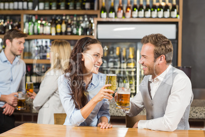 Couples looking at each other while holding beer