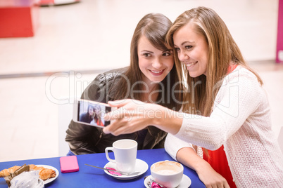 Women taking a selfie while having coffee